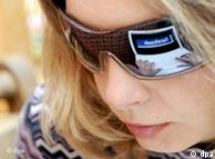 woman's face with facebook reflected in glasses