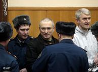 Mikhail Khodorkovsky, center, and his original co-defendant Platon Lebedev, right