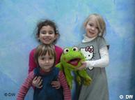 Kids holding stuffed frog