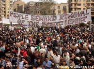 Egyptian protesters hold a big banner during a demonstration in Tahrir square, in Cairo, Egypt, 04 February 2011