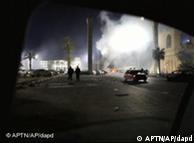 A fire burns on a street in Tripoli