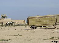 A destroyed military vehicle is seen in front of not working radar and an anti-aircraft missile at an abandoned Libyan military base near Tobruk