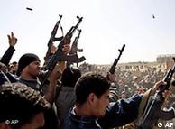 Libyan rebels fire in the air during a mass funeral in Ajdabiya, eastern Libya