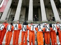 Back-dropped by columns of the National Gallery, campaigners in orange jumpsuits from the London Guantanamo Campaign hold a silent vigil in Trafalgar Square, London Tuesday, Jan. 11, 2011. Human rights groups demanded the release of the last British inmate at Guantanamo Bay on Tuesday, donning orange jumpsuits to demonstrate against the U.S. prison's ninth anniversary. (AP Photo/Akira Suemori)