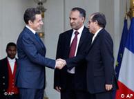 French President Nicolas Sarkozy, left, shakes hands with Mahmoud Jibril, right, and Ali Al-Esawi
