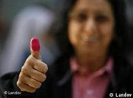 A voter does the thumbs up after casting her vote
