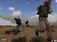 Libyan rebels are shrouded in smoke from their own munitions 