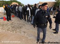 Line of migrants and a police officer