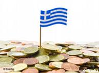 Euro coins and a Greek flag