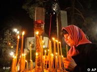 A woman lights a candle in Kiev, Ukraine