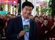 FILE- In this March 20, 2011 file photo, Tibetan prime ministerial candidate Lobsang Sengey, shows his green book as he arrives to cast his vote in Dharmsala, India. Legal expert Sangay has won the election to become head of the Tibetan government-in-exile, taking over the Dalai Lama's political role.(AP Photo/Ashwini Bhatia, File)