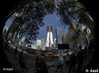 Pedestrians and traffic travel along Church Street as the new One World Trade Center, center, stands glistening in the morning sun