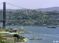 A cargo ship passes under the Bosporus bridge as it sets sail  in Istanbul